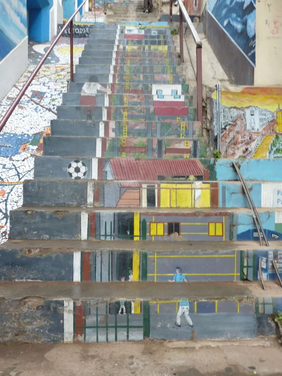 Concrete stairs with images of children playing football painted onto them