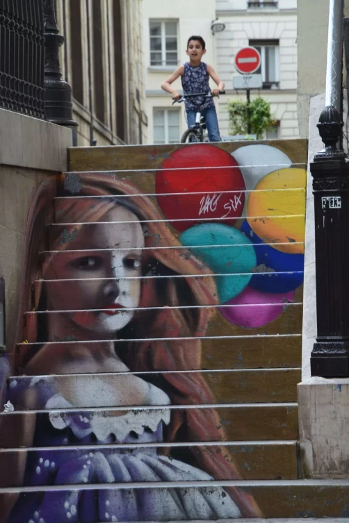 Portrait of a girl with balloons painted on a concrete staircase