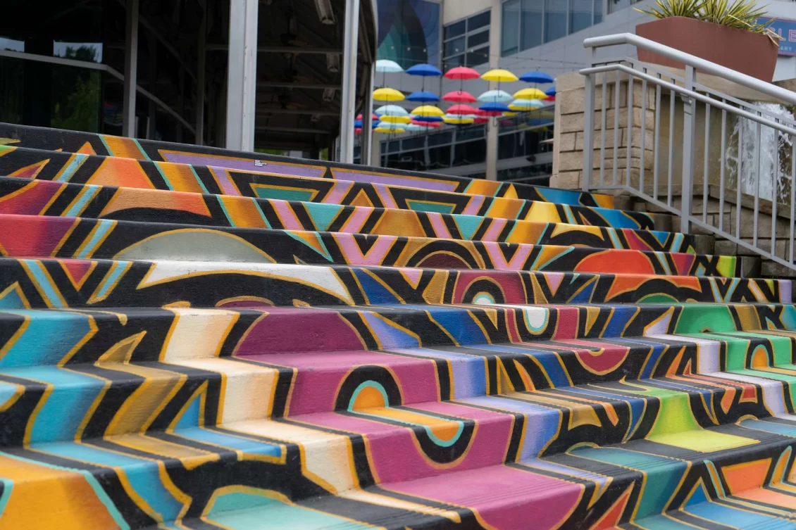 Outdoor steps painted with bright colours in an abstract pattern